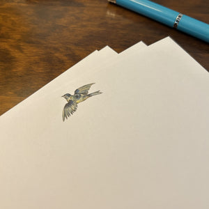 a blue pen sitting on top of a piece of paper